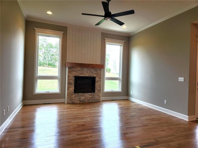 unfurnished living room with crown molding, ceiling fan, and dark wood-type flooring