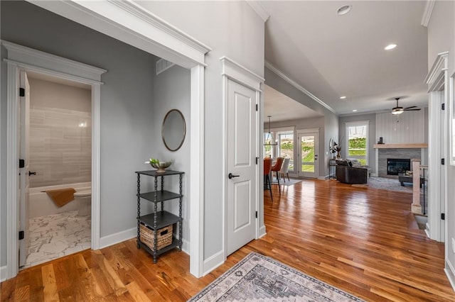 hallway featuring crown molding and wood-type flooring