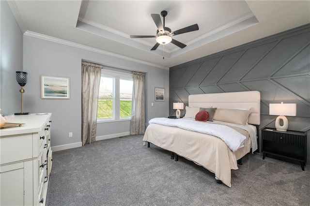 carpeted bedroom with ornamental molding, a raised ceiling, and ceiling fan