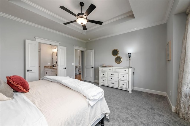 carpeted bedroom featuring crown molding, ceiling fan, connected bathroom, and a tray ceiling