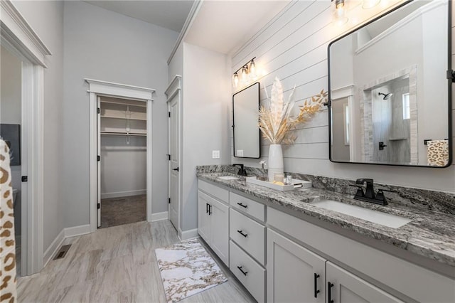 bathroom with vanity and a shower