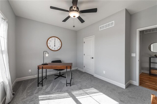 carpeted office featuring ceiling fan