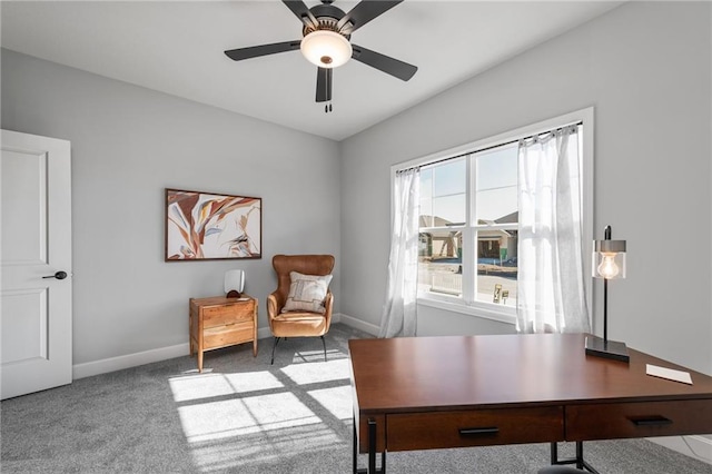 carpeted home office featuring ceiling fan