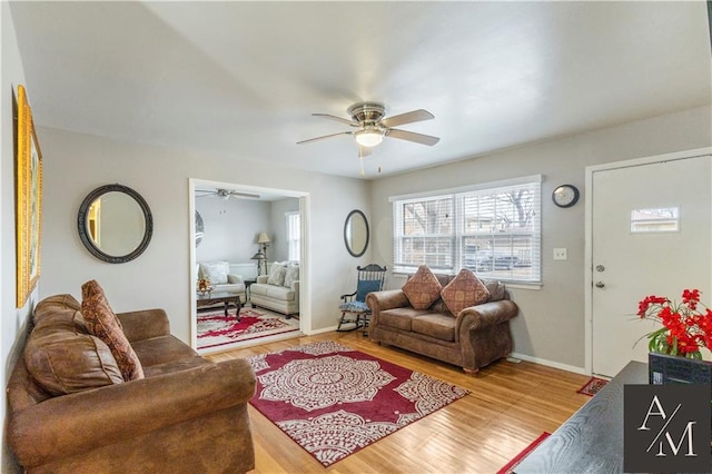 living room featuring hardwood / wood-style floors and ceiling fan