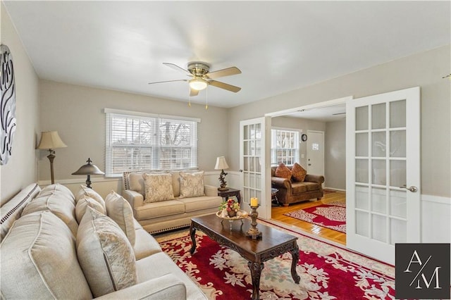 living room featuring french doors, ceiling fan, and hardwood / wood-style floors