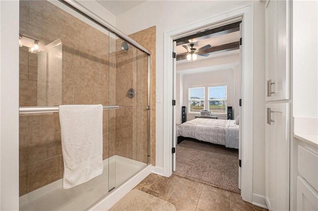 bathroom featuring ceiling fan and a shower with door