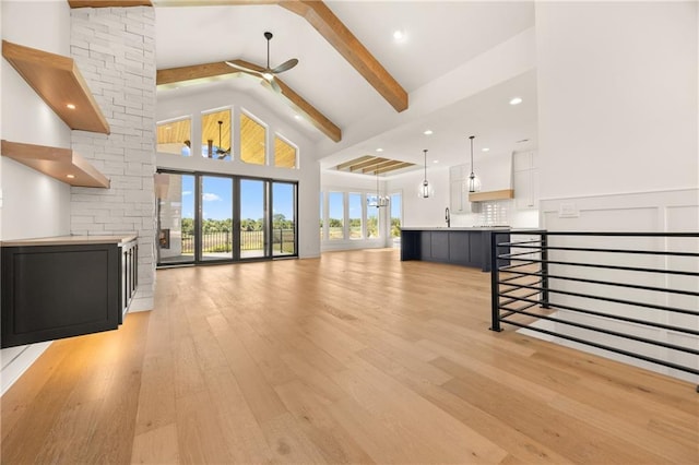 17021 Parkhill St, Overland Park, KS 66221 - unfurnished living room with ceiling fan, light wood-style floors, high vaulted ceiling, beam ceiling, and recessed lighting