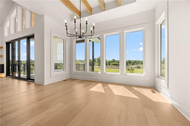 17021 Parkhill St, Overland Park, KS 66221 - unfurnished dining area featuring light wood-style flooring, beam ceiling, and a chandelier