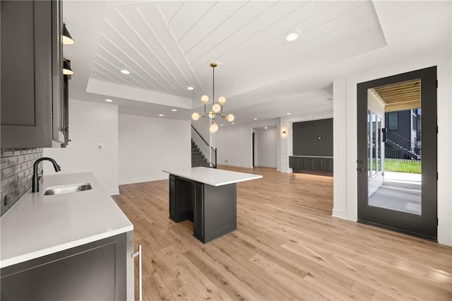 17021 Parkhill St, Overland Park, KS 66221 - kitchen with open floor plan, light countertops, a kitchen island, a raised ceiling, and wooden ceiling