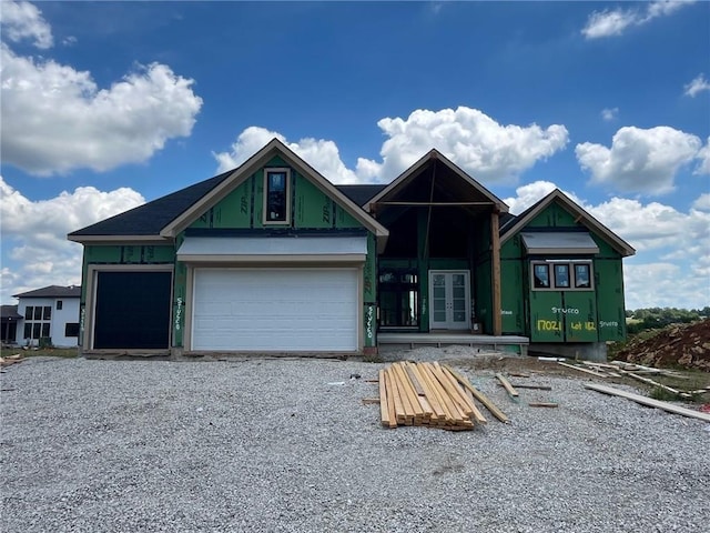 17021 Parkhill St, Overland Park, KS 66221 - property under construction with french doors, gravel driveway, and a garage