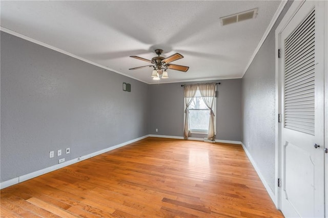 spare room featuring crown molding, ceiling fan, and light hardwood / wood-style flooring