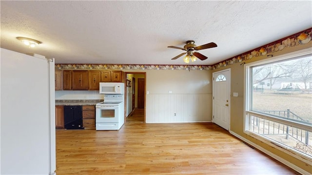 kitchen featuring ceiling fan, white appliances, a textured ceiling, and light wood-type flooring