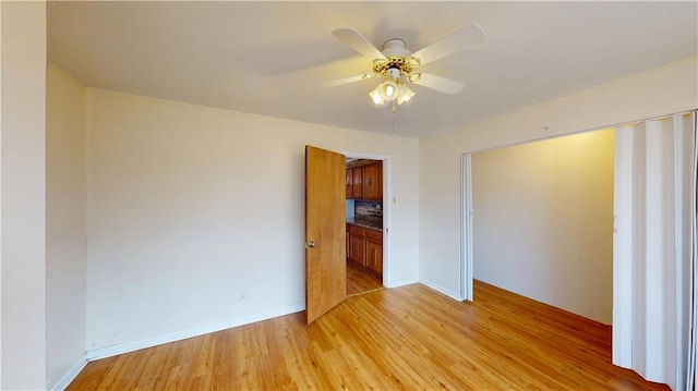 unfurnished bedroom featuring light hardwood / wood-style flooring, a closet, and ceiling fan