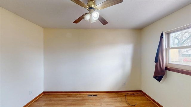 empty room with ceiling fan and light hardwood / wood-style flooring