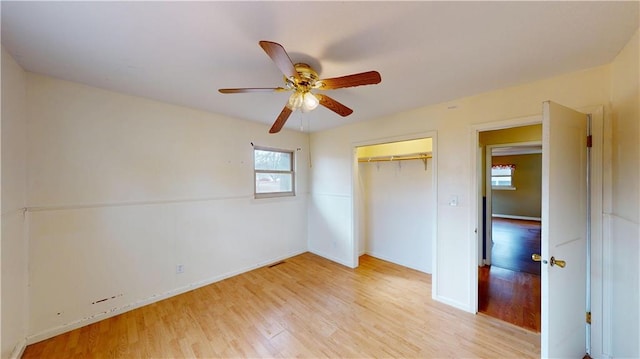 unfurnished bedroom featuring ceiling fan, light hardwood / wood-style floors, and a closet