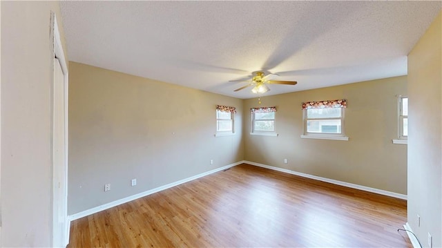 spare room featuring ceiling fan, a textured ceiling, and light wood-type flooring