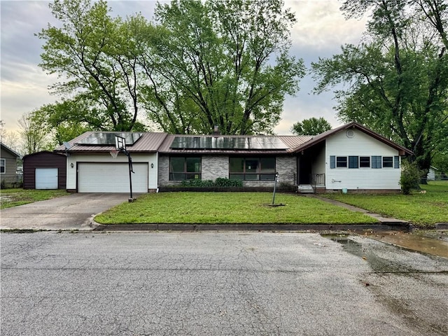 1120 N Oak St, Nevada, MO 64772 - ranch-style home with a garage, driveway, metal roof, and a front lawn