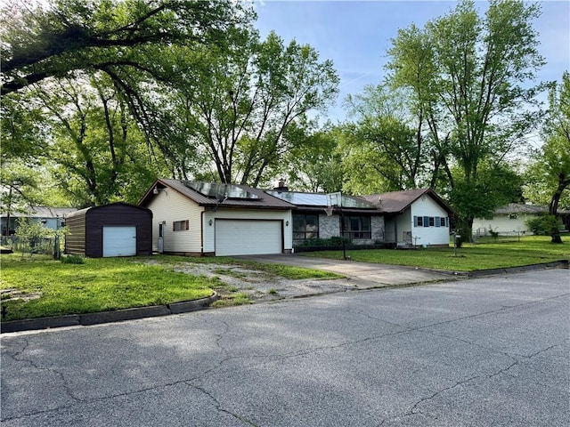 1120 N Oak St, Nevada, MO 64772 - ranch-style home featuring aphalt driveway, a chimney, solar panels, and a front lawn