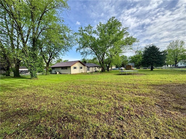 1120 N Oak St, Nevada, MO 64772 - view of yard featuring a trampoline