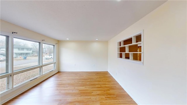 1120 N Oak St, Nevada, MO 64772 - unfurnished room featuring baseboards, recessed lighting, and light wood-style flooring