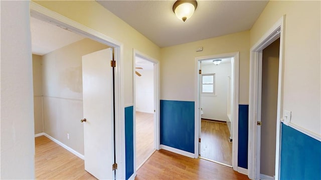 1120 N Oak St, Nevada, MO 64772 - hallway with baseboards and wood finished floors
