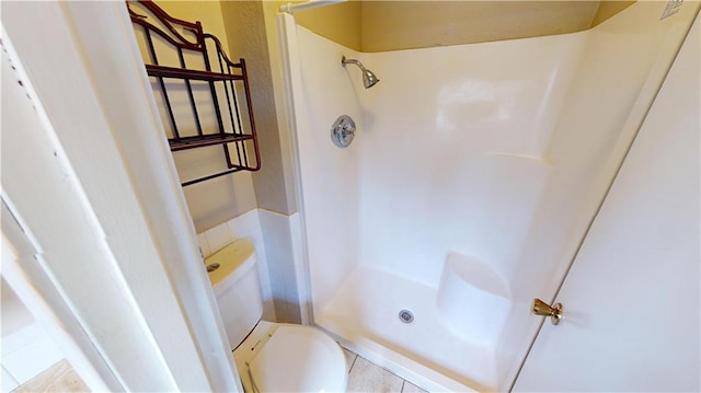 1120 N Oak St, Nevada, MO 64772 - bathroom with tile patterned flooring, a walk in shower, and toilet