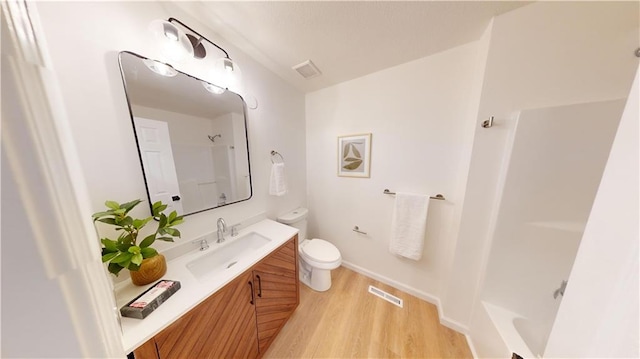 bathroom featuring vanity, toilet, and hardwood / wood-style floors