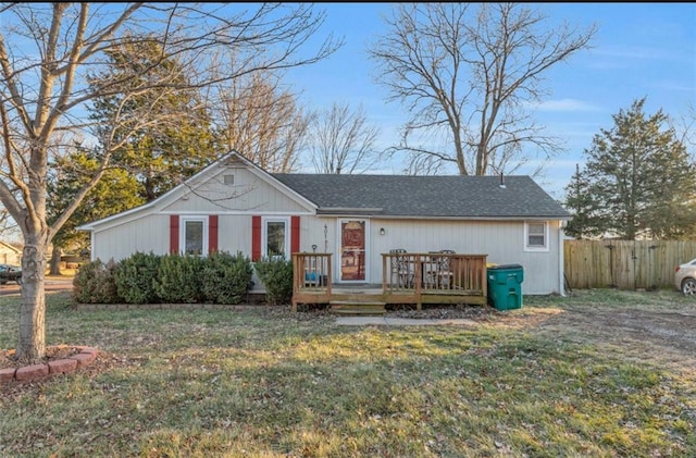 ranch-style house with a deck and a front lawn