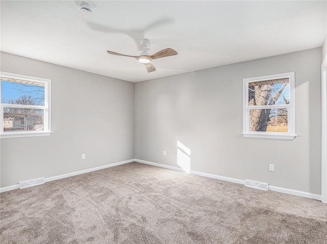 unfurnished room with ceiling fan, a healthy amount of sunlight, and carpet