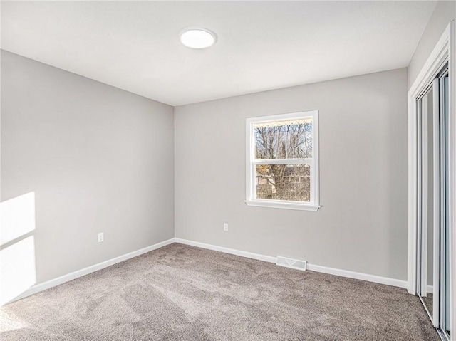 unfurnished bedroom with carpet flooring and a closet