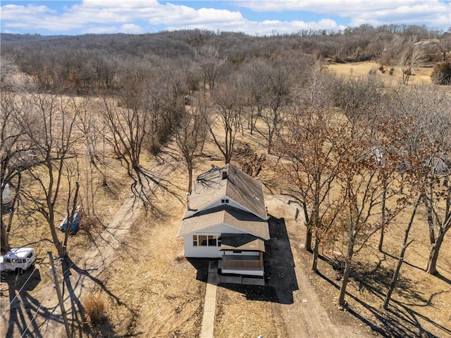 birds eye view of property with a wooded view