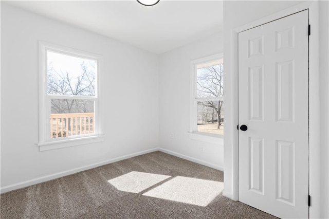 empty room with carpet floors and baseboards