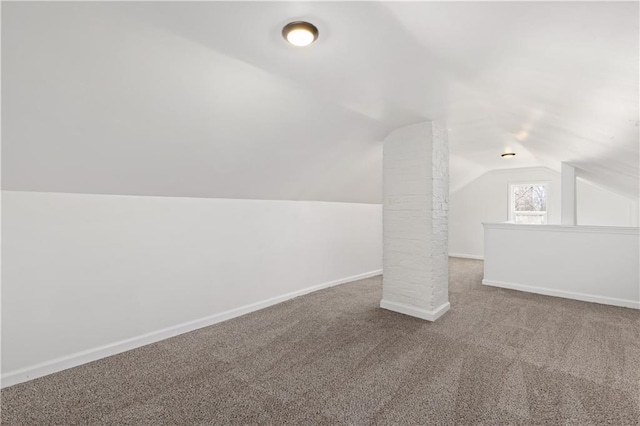 bonus room with lofted ceiling, carpet flooring, and baseboards