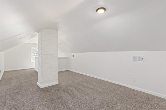 additional living space with lofted ceiling, carpet, visible vents, and baseboards