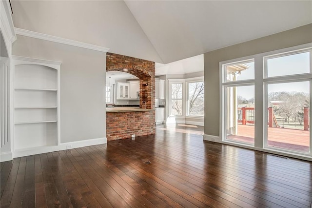 4300 SE Willow Ridge Dr, Blue Springs, MO 64014 - unfurnished living room featuring built in shelves, dark wood-type flooring, and high vaulted ceiling