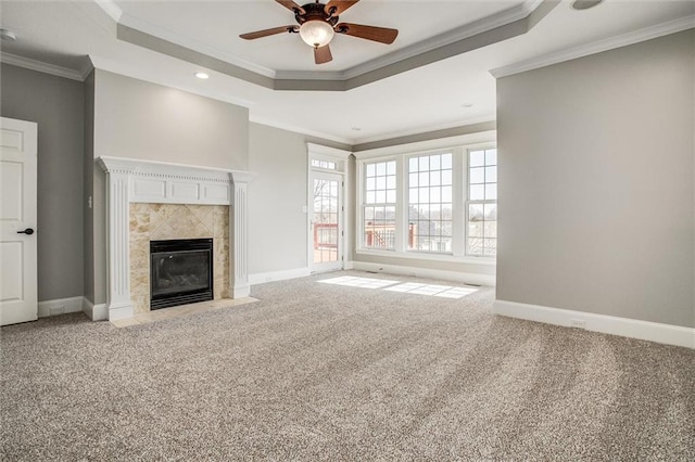 4300 SE Willow Ridge Dr, Blue Springs, MO 64014 - unfurnished living room featuring a tiled fireplace, carpet floors, ornamental molding, and a raised ceiling
