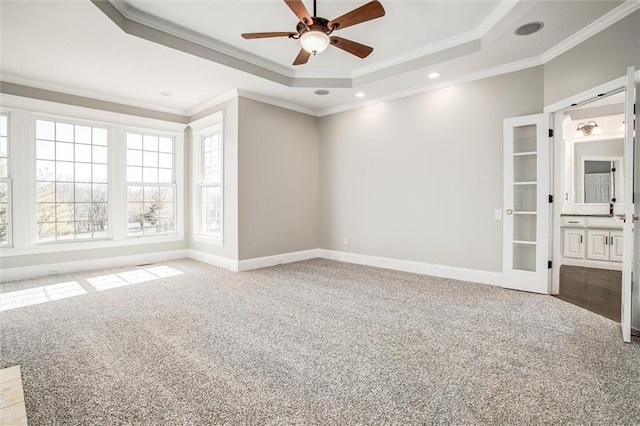 4300 SE Willow Ridge Dr, Blue Springs, MO 64014 - empty room featuring a tray ceiling, ornamental molding, light colored carpet, and ceiling fan