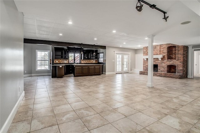 4300 SE Willow Ridge Dr, Blue Springs, MO 64014 - unfurnished living room featuring light tile patterned floors, a fireplace, and french doors