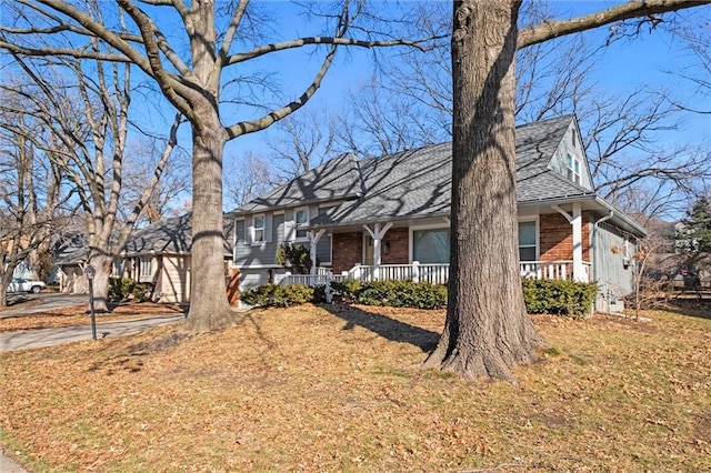 view of front facade with a front yard and a porch