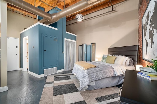 bedroom with a towering ceiling and a closet