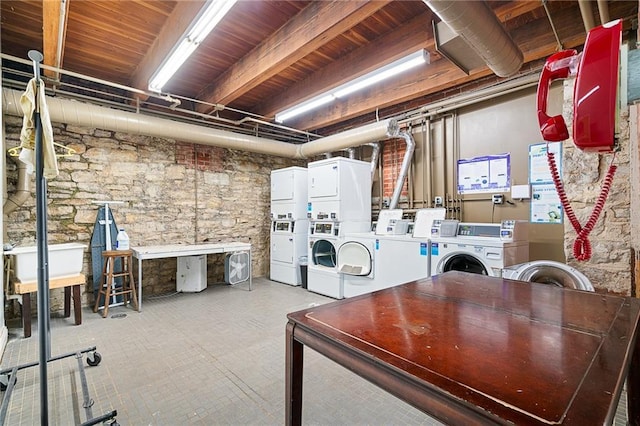 basement featuring stacked washing maching and dryer and washing machine and dryer