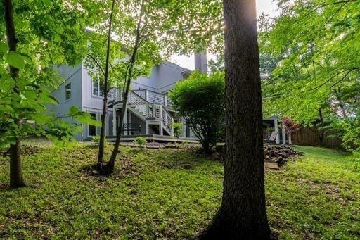 view of yard featuring stairway and fence