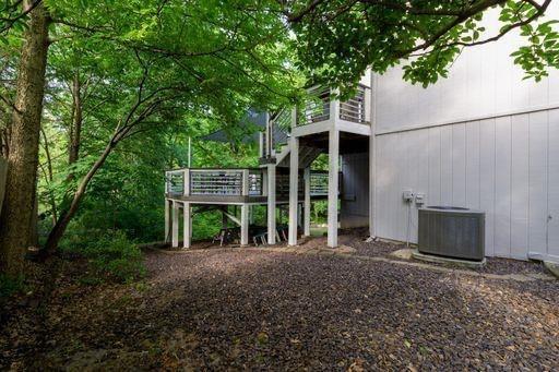 exterior space featuring cooling unit and a wooden deck