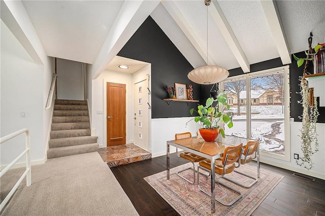 dining area with dark wood-style flooring, visible vents, stairway, a textured ceiling, and baseboards