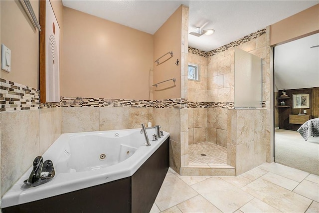 ensuite bathroom featuring tile patterned flooring, a shower stall, a whirlpool tub, and ensuite bathroom