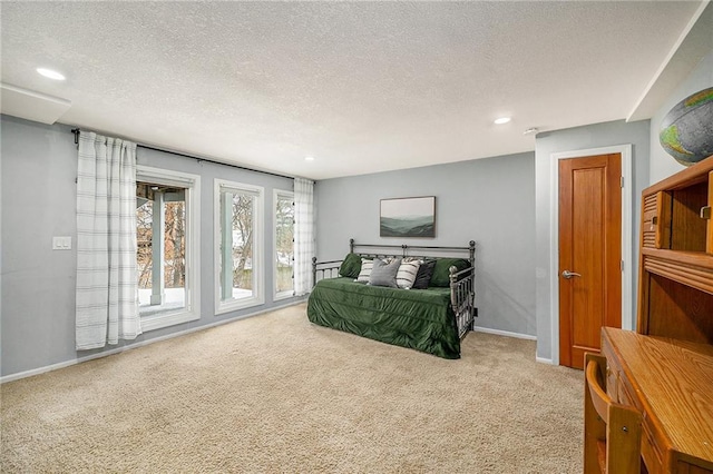 carpeted bedroom with baseboards, a textured ceiling, and recessed lighting