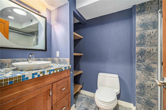 full bathroom with visible vents, baseboards, toilet, stone finish floor, and vanity