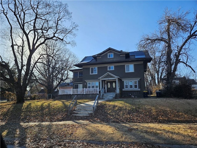 view of front facade with solar panels