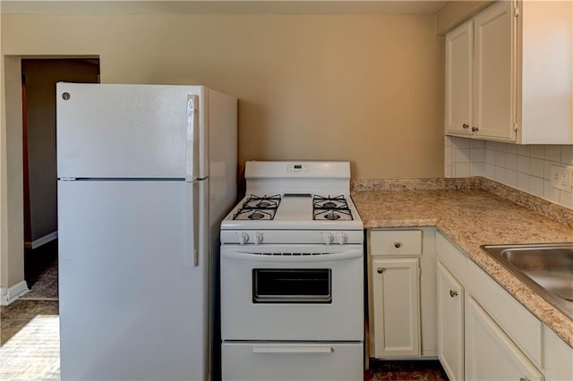 kitchen with white cabinetry, sink, white appliances, and decorative backsplash