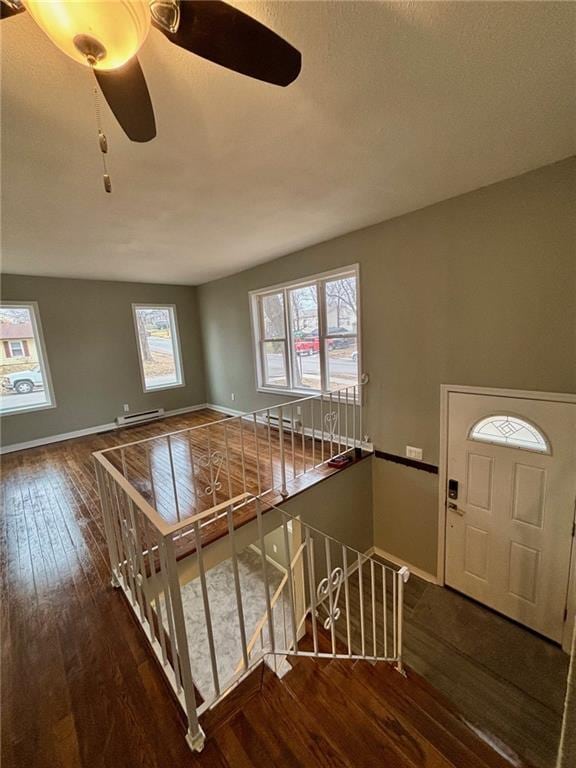 entryway featuring dark hardwood / wood-style flooring, a baseboard radiator, and ceiling fan